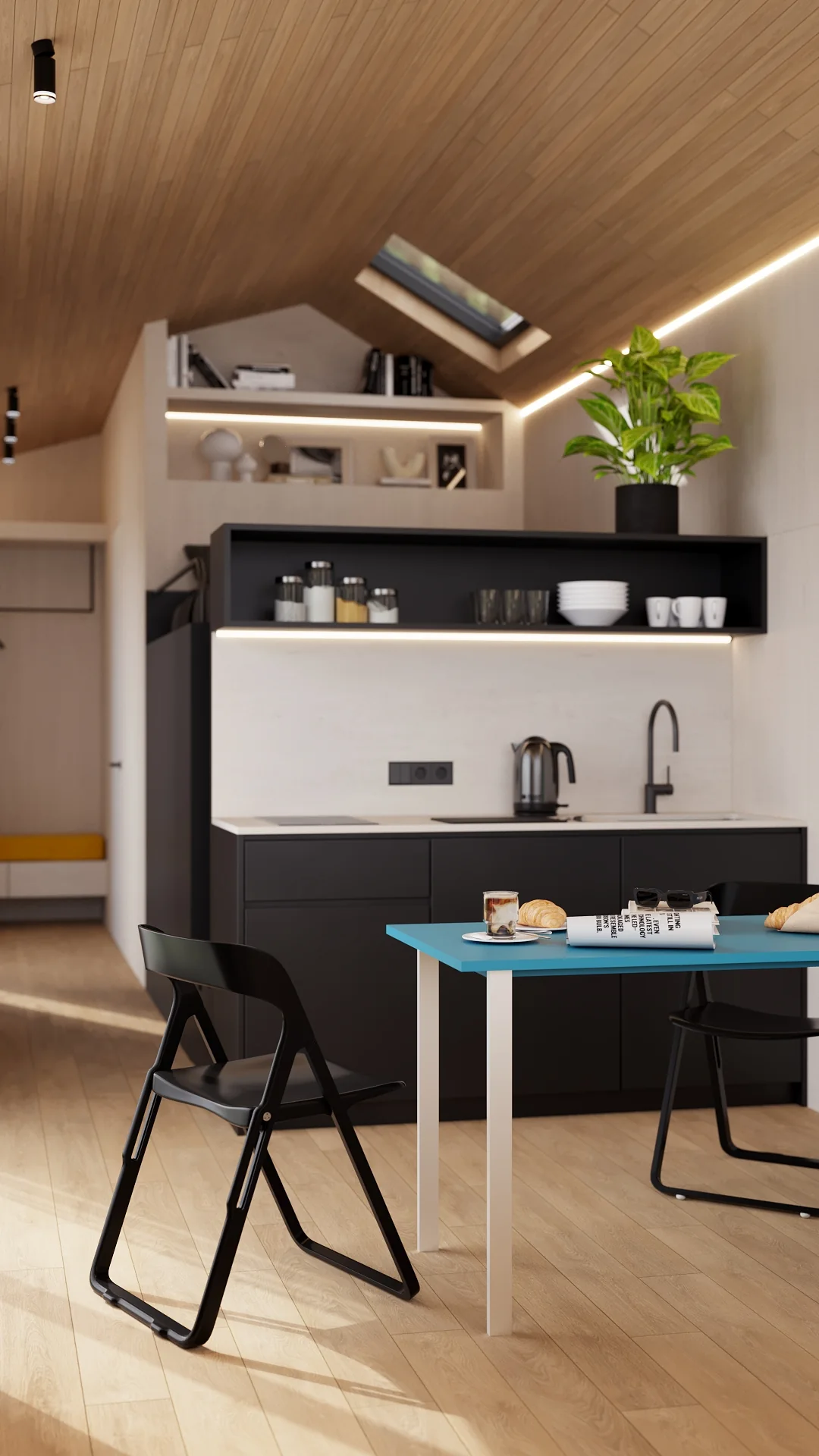 Alpina kitchen with blue fold-out table and warm ceiling lighting
