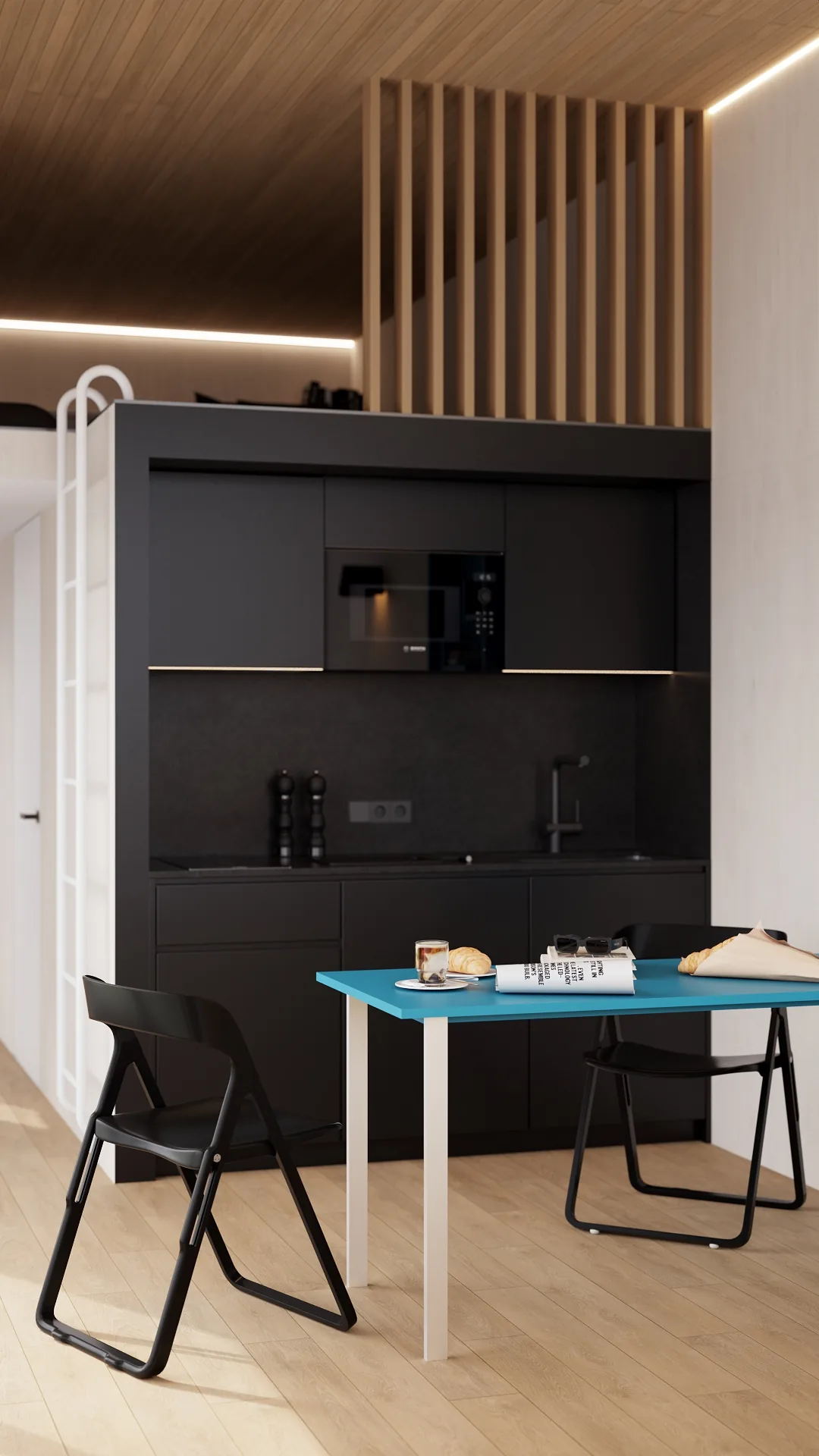 Magnum modular home — black compact kitchen and blue dining table QHome Magnum modular home — black compact kitchen and blue dining table